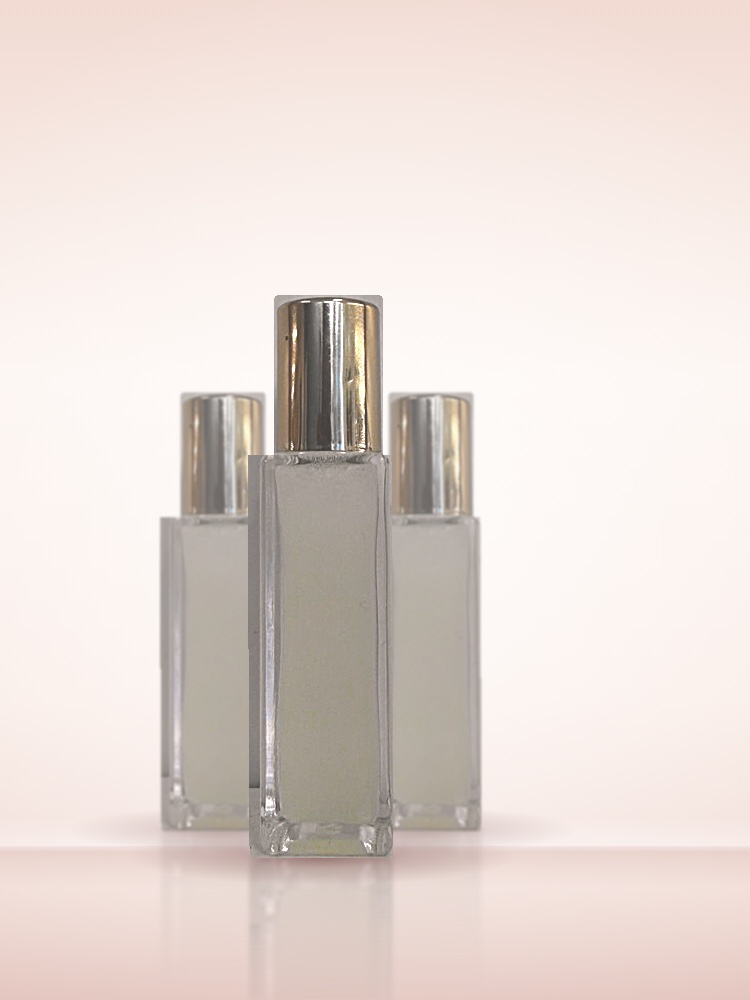 Three Loom rollerball bottles with brushed gold caps on a blush studio backdrop